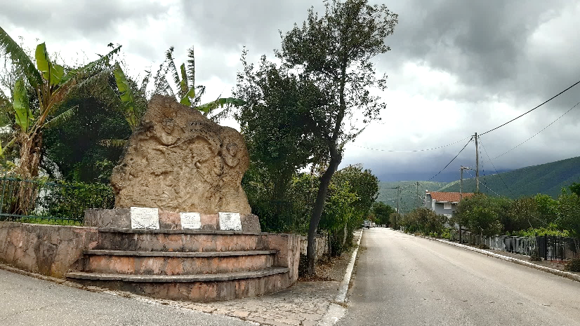 In a mountain village:Reliefs with images of battle carved into a rock in the courtyard of a house.